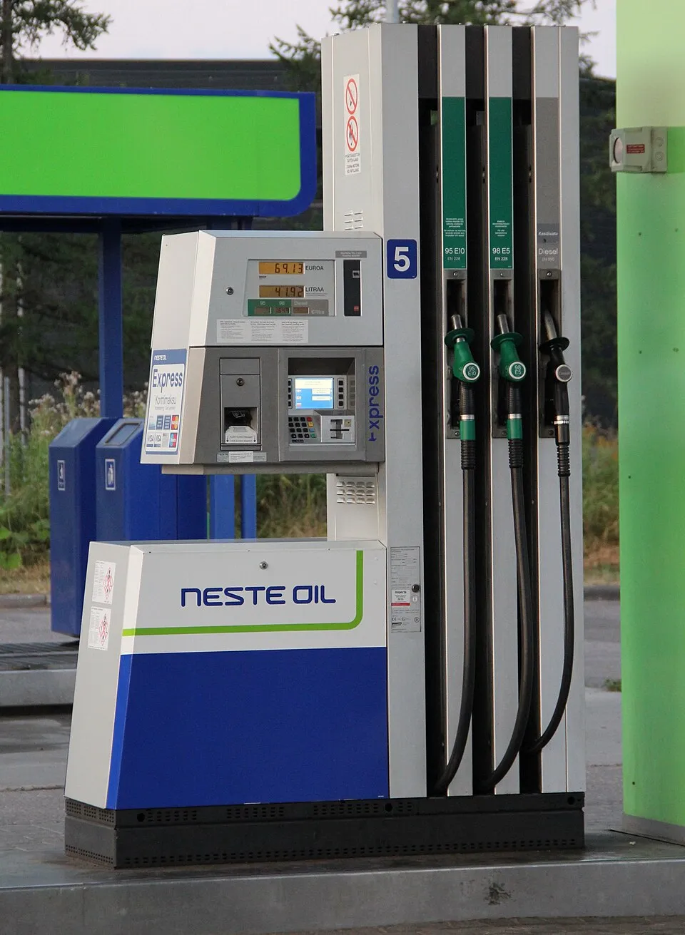 A diesel nozzle alongside petrol nozzles at a Neste Oil filling station pump