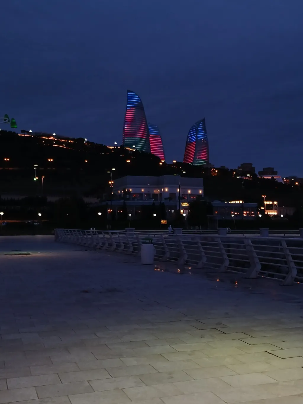 Flame Towers in Baku, Azerbaijan, lit in blue, red and green at night, seen from Baku Boulevard