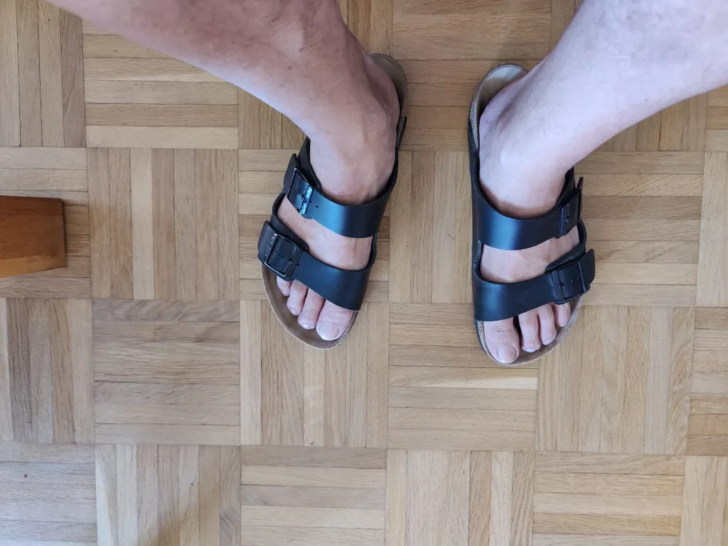 A pair of black Birkenstock Arizona sandals.