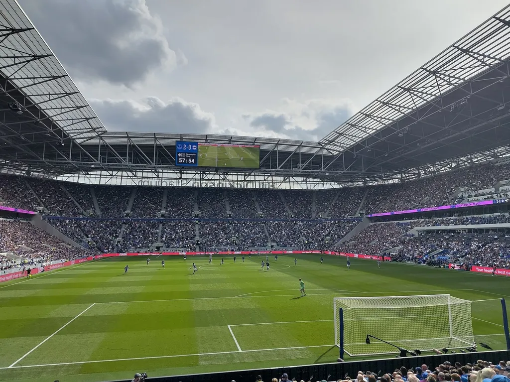 Crowd of football supporters in the stands of an English football stadium during a match