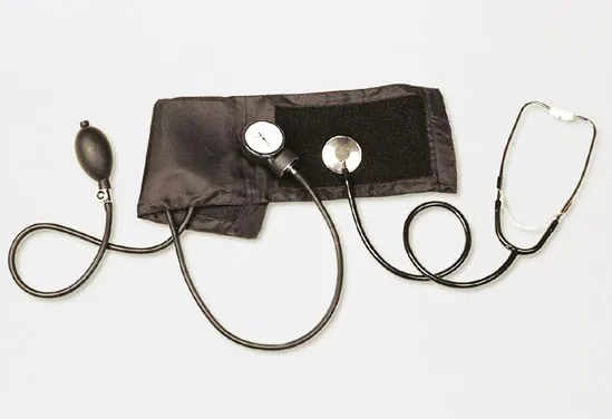 A manual blood-pressure cuff with a round pressure gauge, inflation bulb and a stethoscope on a white background.