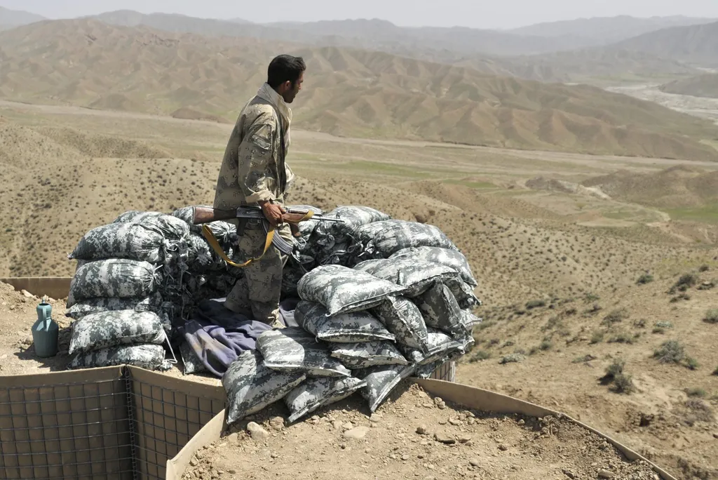 An Afghan border policeman stands watch at a checkpoint near the Afghanistan-Pakistan border in Spin Boldak, Kandahar province