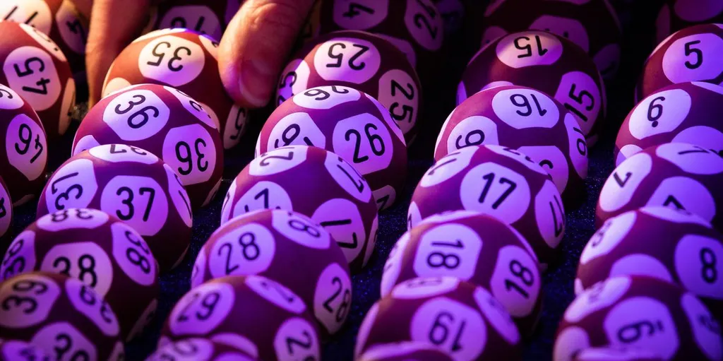 Close-up of actual EuroMillions draw balls with their numbers, held in the draw machine.