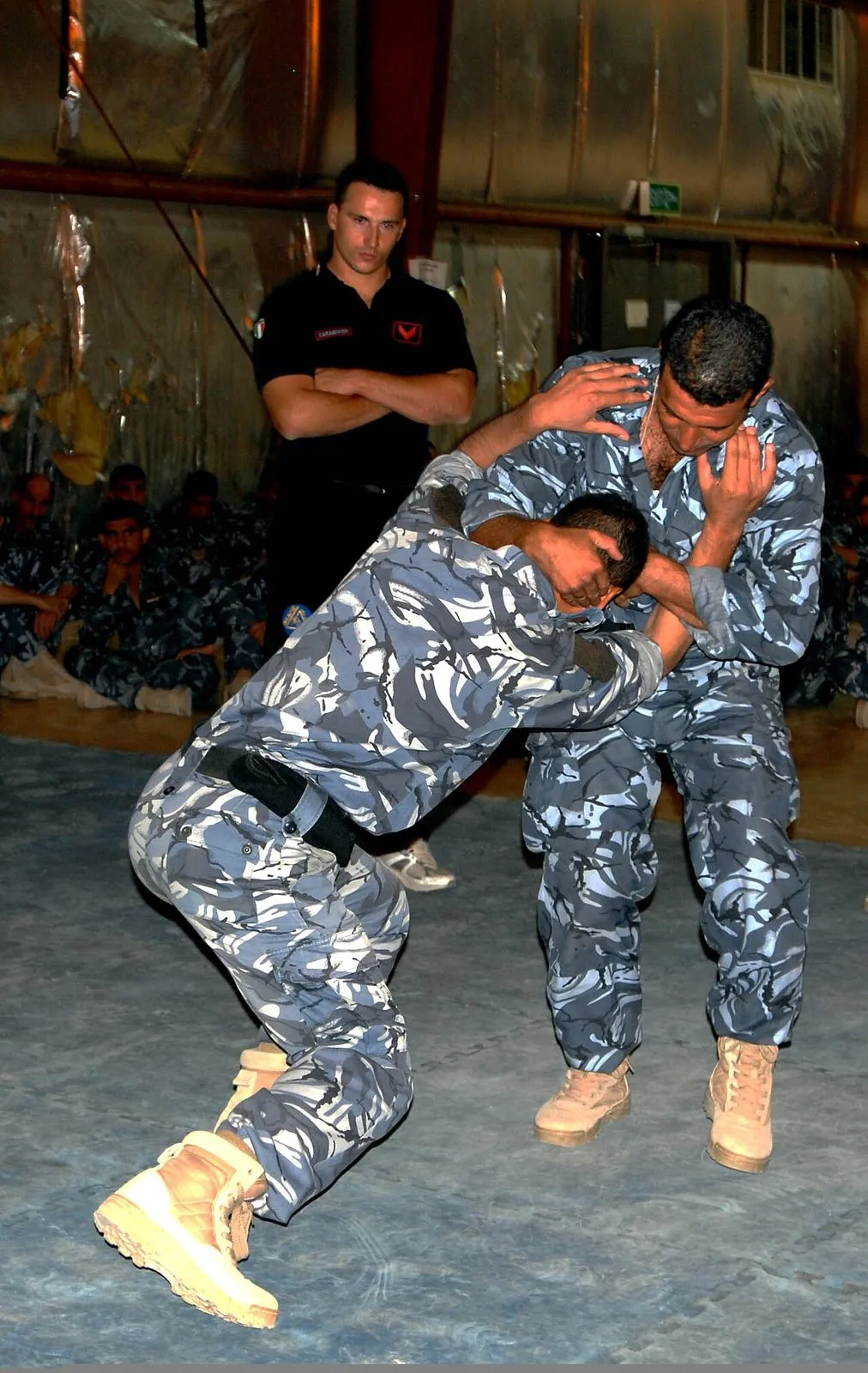 An Italian Carabinieri officer observes Iraqi police self-defence training at Camp Dublin, Iraq, in August 2011.