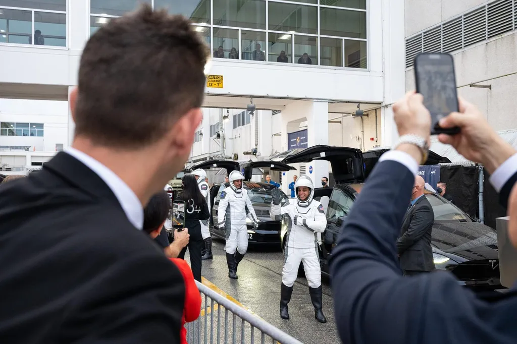 The four Crew-13 astronauts in white SpaceX suits wave to onlookers during their walkout to the launch pad at Kennedy Space Center on Oct 1, 2026.