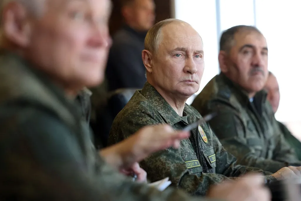 Vladimir Putin in military uniform observing military drills alongside Russian officers.