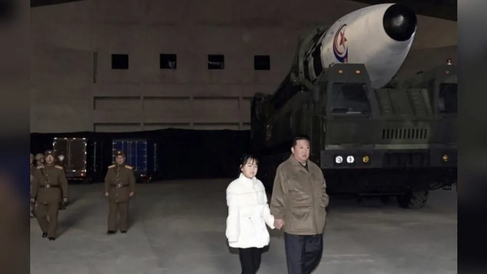 Kim Jong Un with his daughter beside a North Korean missile on its launcher (KCNA file photo)