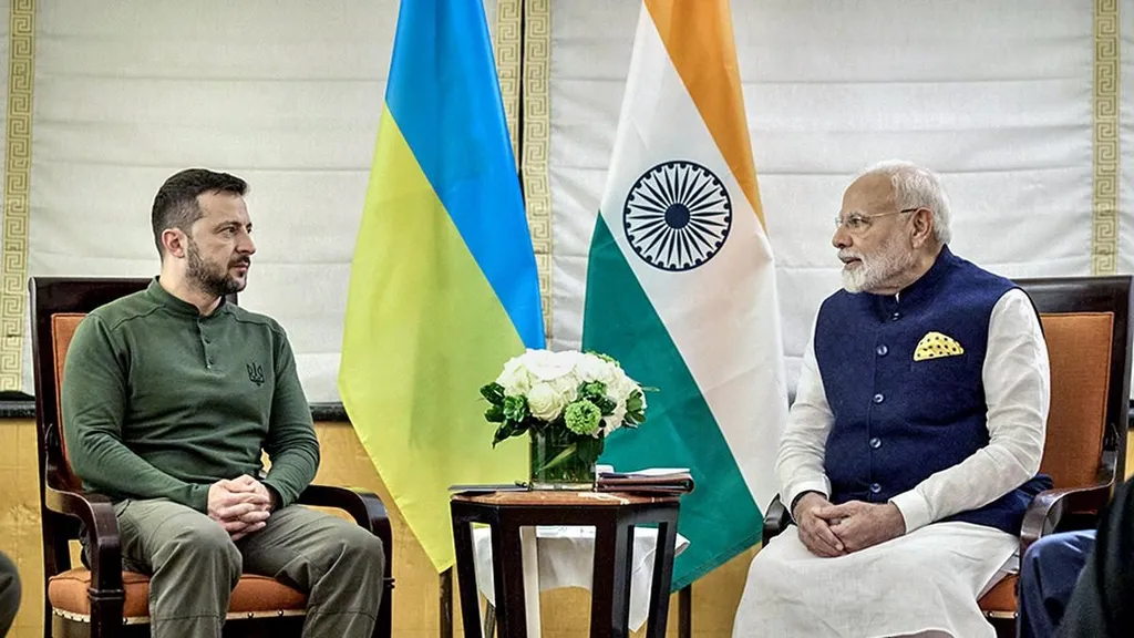 Prime Minister Narendra Modi and Ukraine President Volodymyr Zelenskyy seated together with Ukrainian and Indian flags
