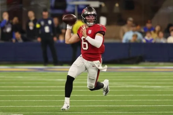 Buccaneers quarterback Baker Mayfield rolls out to throw against the Rams