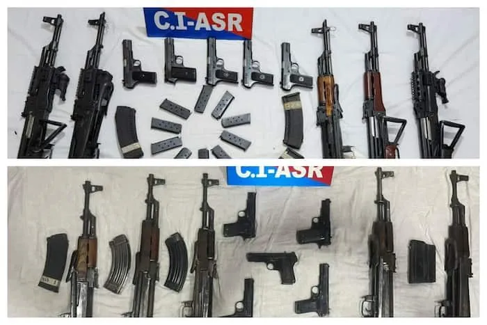 Seized AK-47 rifles, pistols and magazines displayed by Punjab police with a C.I.-ASR sign