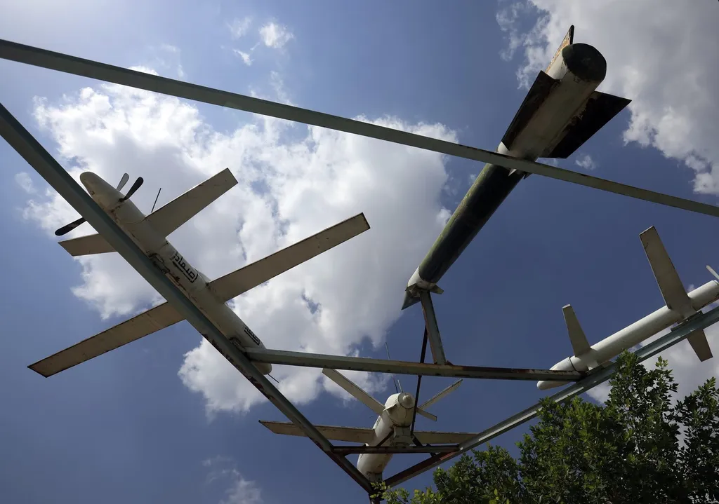 Houthi missiles and drones on display against a blue sky