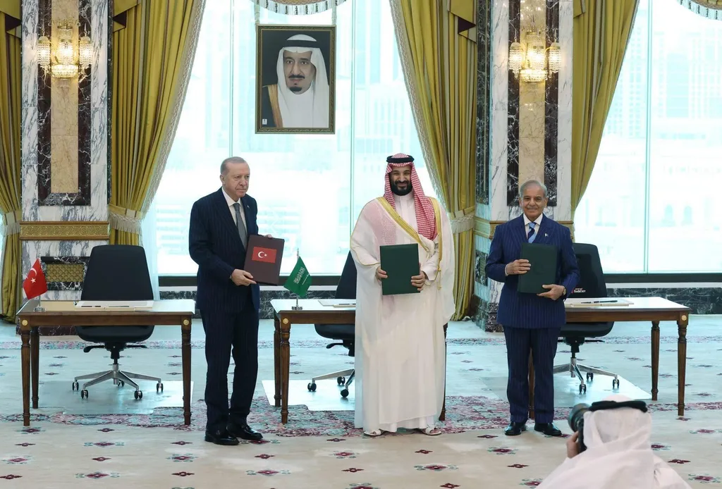 Recep Tayyip Erdogan, Mohammed bin Salman and Shehbaz Sharif hold the signed Makkah defence pact documents in Riyadh
