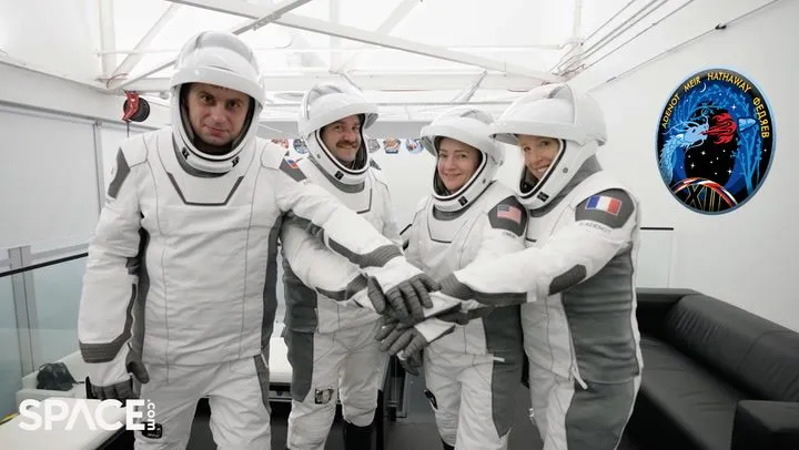 The four Crew-12 astronauts in SpaceX suits with their mission patch visible