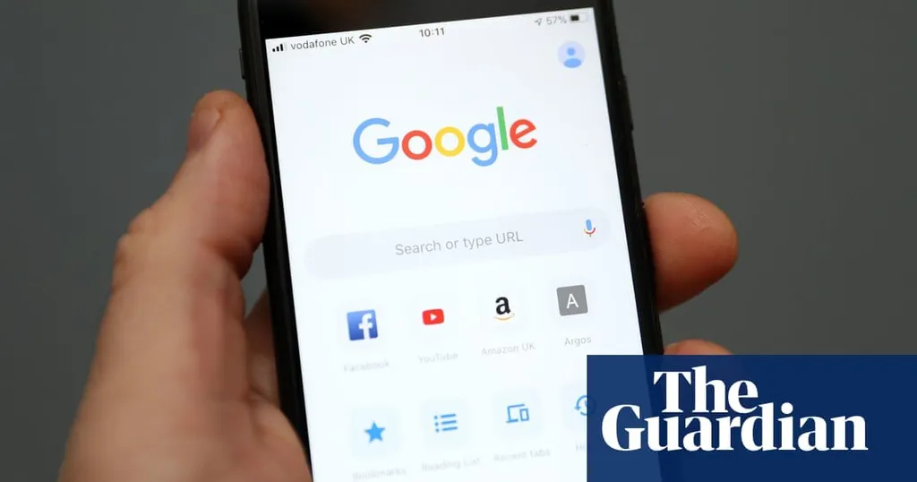A hand holding a smartphone showing the Google homepage
