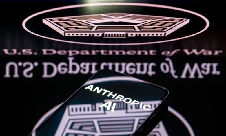 A phone displaying the Anthropic AI logo over the US Department of Defense emblem