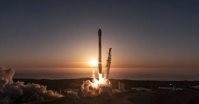 A SpaceX Falcon 9 rocket lifts off from Vandenberg Space Force Base at dawn.