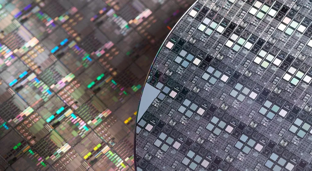 Close-up of silicon wafers patterned with rows of microchips.