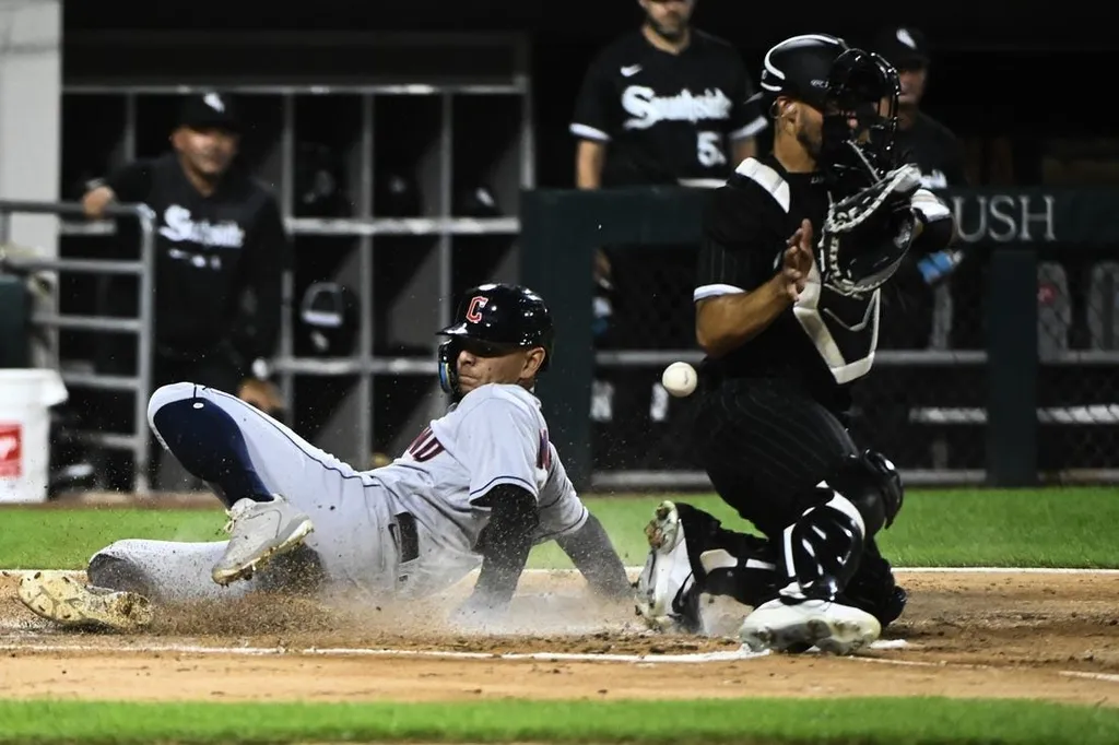 Cleveland Guardians runner sliding home against the Chicago White Sox