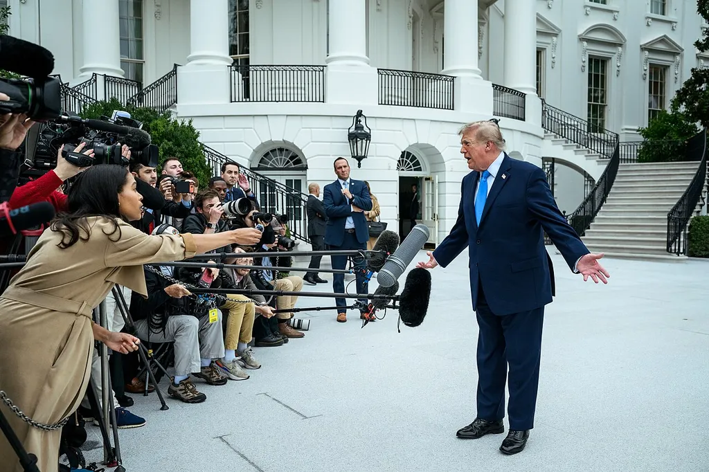 US President Donald Trump gestures with both hands while speaking to members of the media on the South Lawn of the White House.