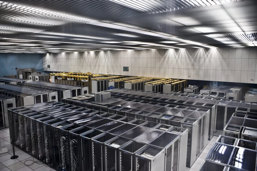 A long corridor of server racks inside a data centre computer hall