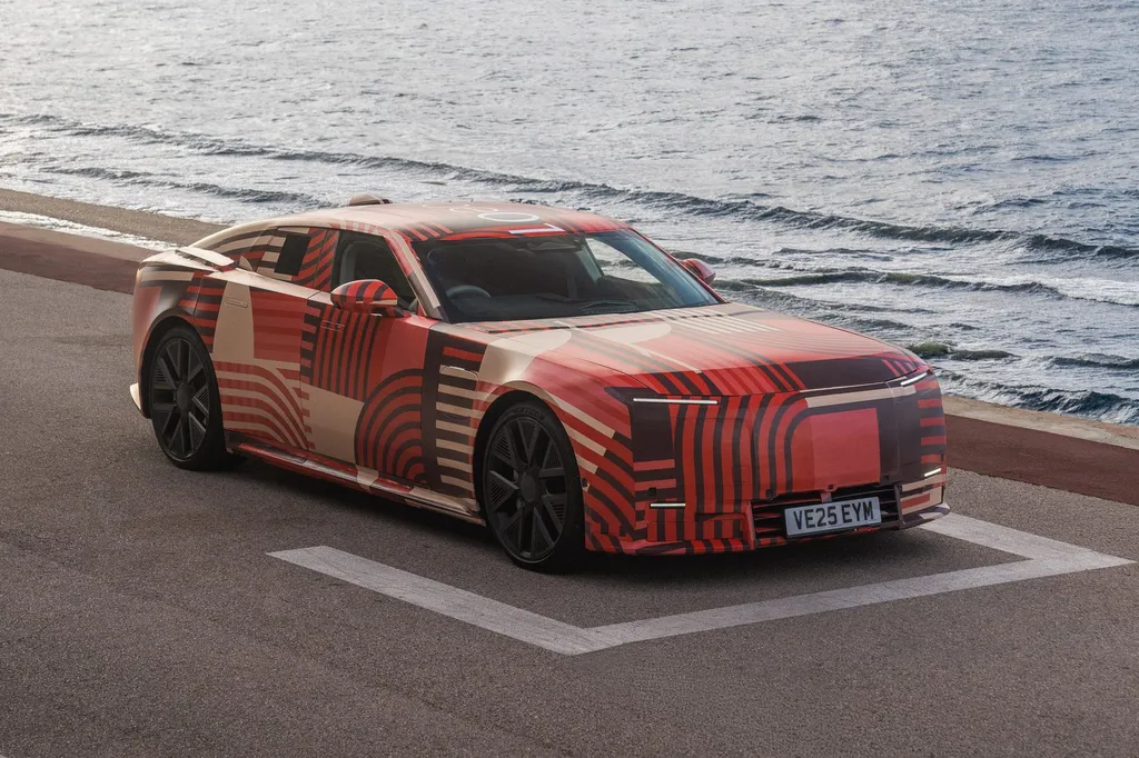 Jaguar Type 01 all-electric car in red camouflage livery parked by the sea