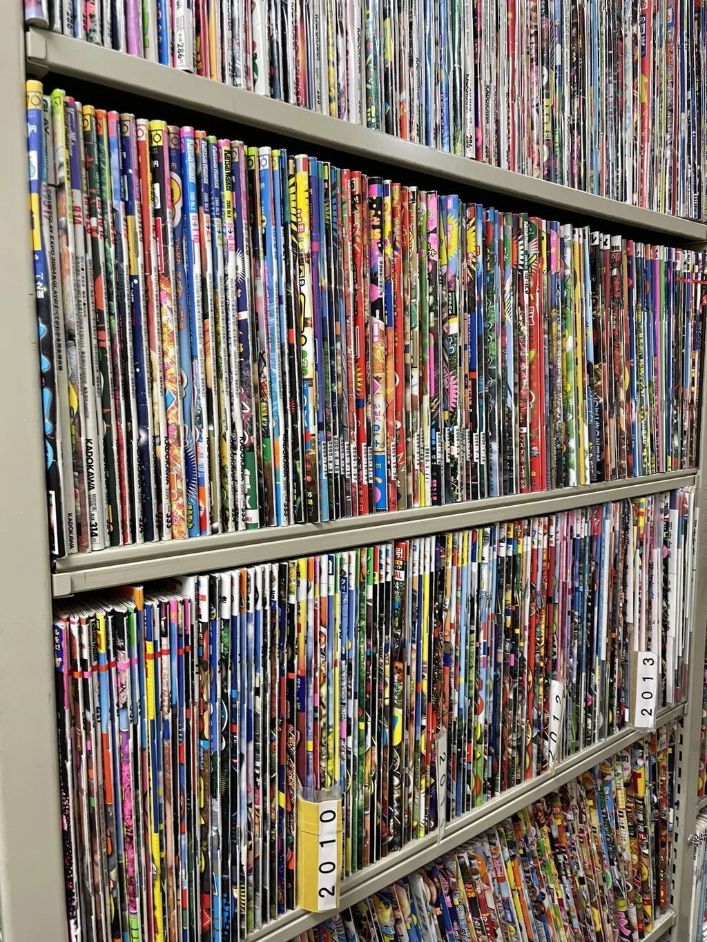 Rows of bound magazines on wooden shelves at the Oya Soichi Library, a magazine-specialised library in Setagaya, Tokyo