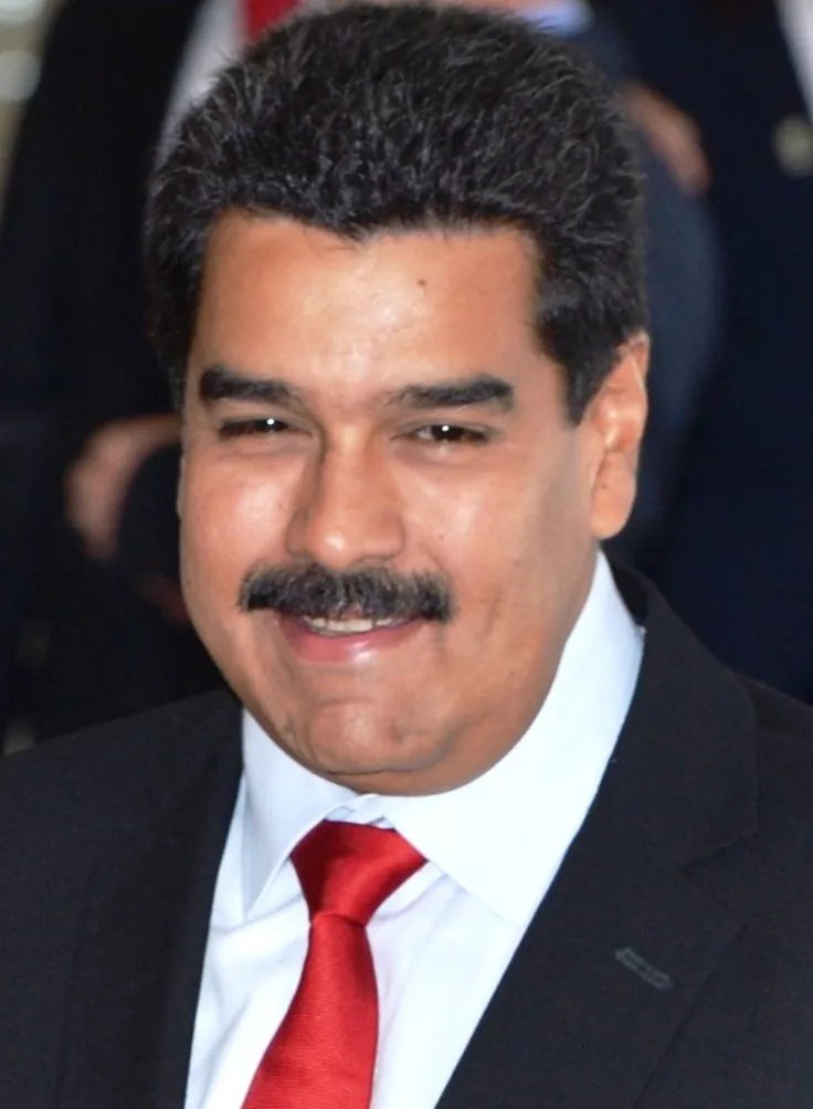 Portrait of former Venezuelan president Nicolás Maduro wearing a dark suit and red tie