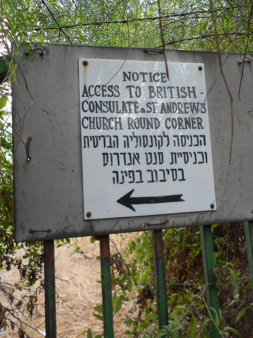A bilingual English-and-Hebrew notice sign directing visitors to the British Consulate in Jerusalem