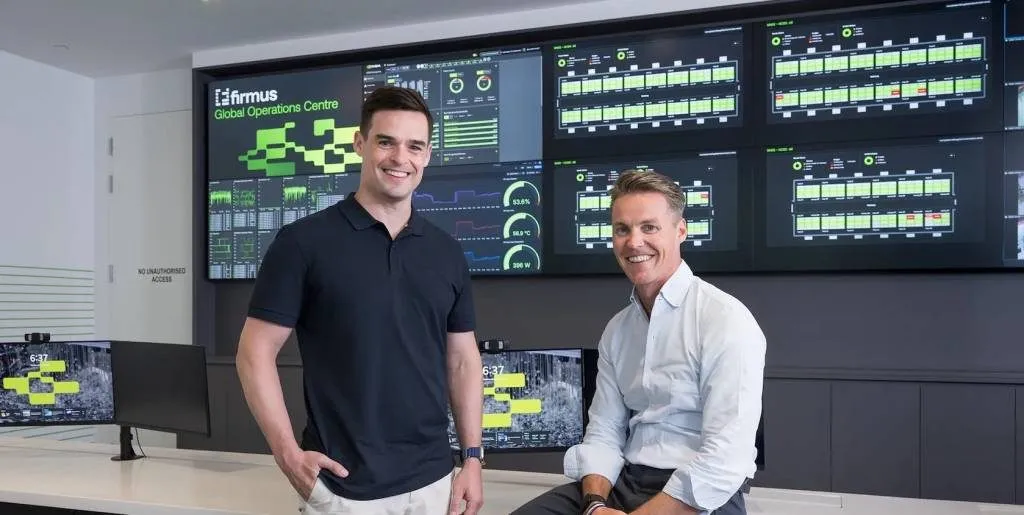 Firmus executives in the company's Global Operations Centre in front of data centre monitoring screens
