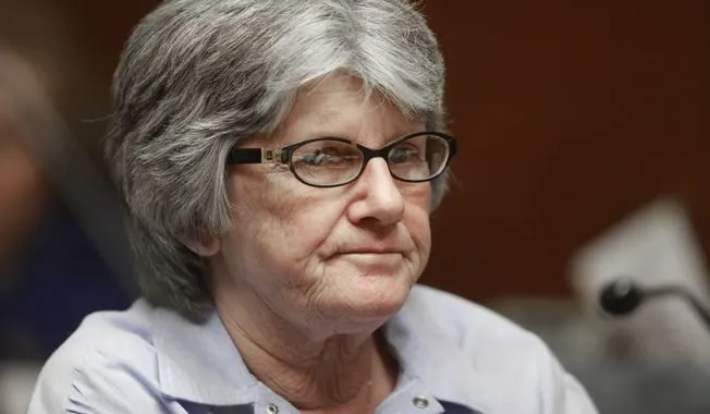 Patricia Krenwinkel, an elderly woman with short gray hair and glasses, seated at a parole hearing