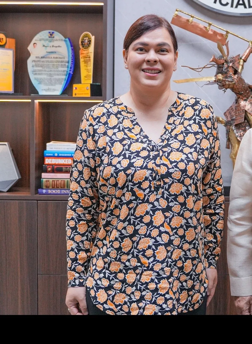 Vice President Sara Duterte photographed in a Senate office in 2025, wearing a dark floral blouse