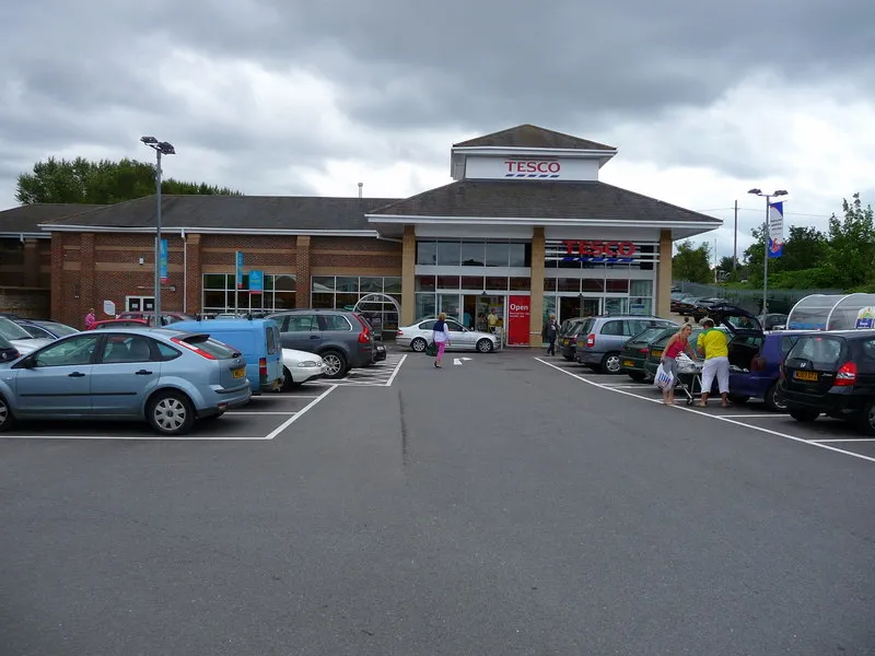 Tesco supermarket storefront in Hungerford, UK, with TESCO signage above the entrance