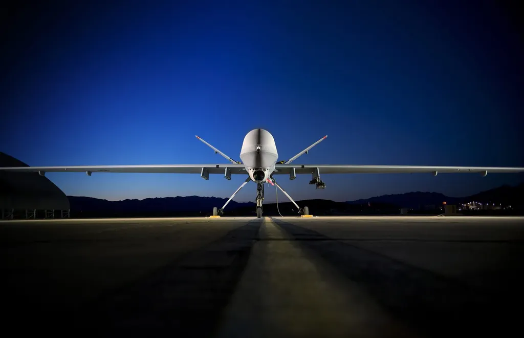 An MQ-9 Reaper drone on a flightline at Creech Air Force Base at night
