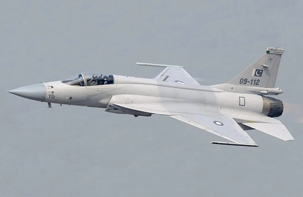 A Pakistan Air Force JF-17 Thunder fighter jet in flight, carrying the Pakistani flag and "Black Spiders" squadron markings on its tail (file photo)