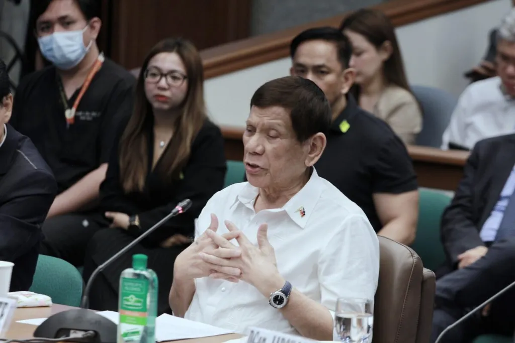Former Philippine president Rodrigo Duterte speaks at a microphone during the Philippine Senate Blue Ribbon Committee hearing into the War on Drugs, 28 October 2024.