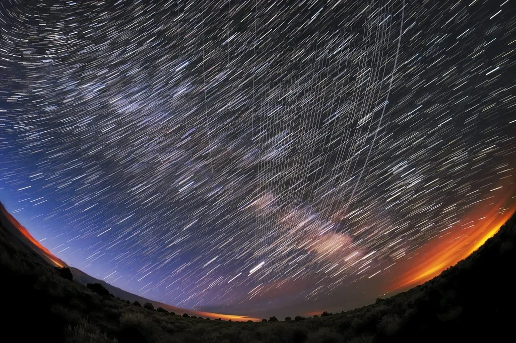 Long-exposure photograph of Starlink satellites streaking across the night sky over Carson National Forest, New Mexico, soon after launch.
