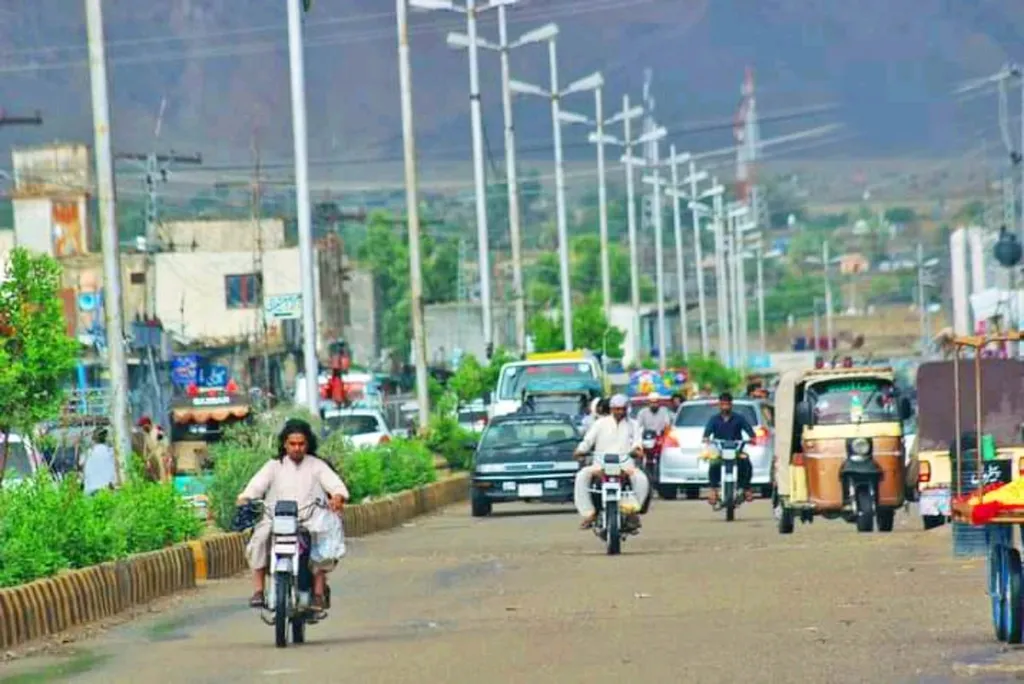 Street scene in Khuzdar, Balochistan, Pakistan, with motorbikes and vehicles on a road