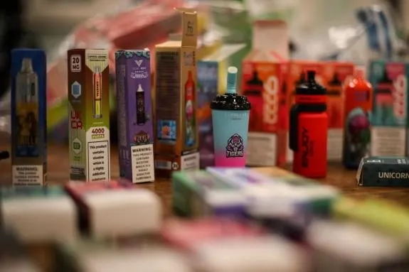 A selection of disposable vapes on a table