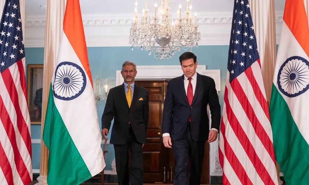 Marco Rubio walks with India's External Affairs Minister S. Jaishankar past US and Indian flags at the US State Department