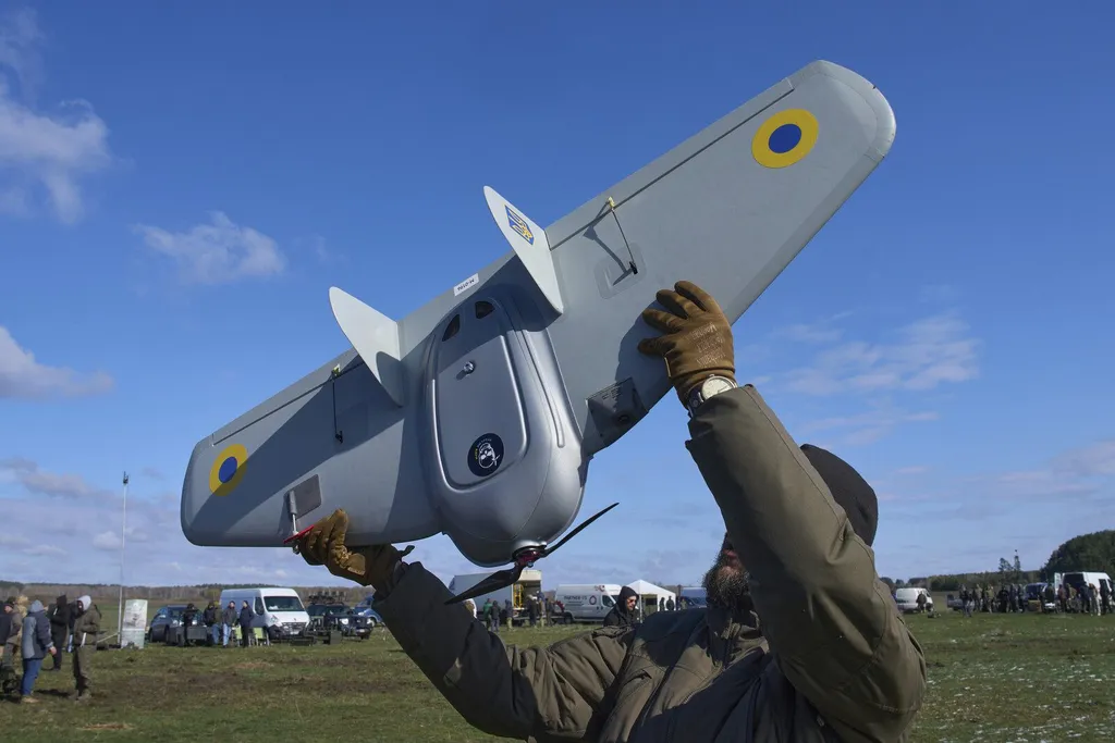 A Ukrainian military drone is launched in a field