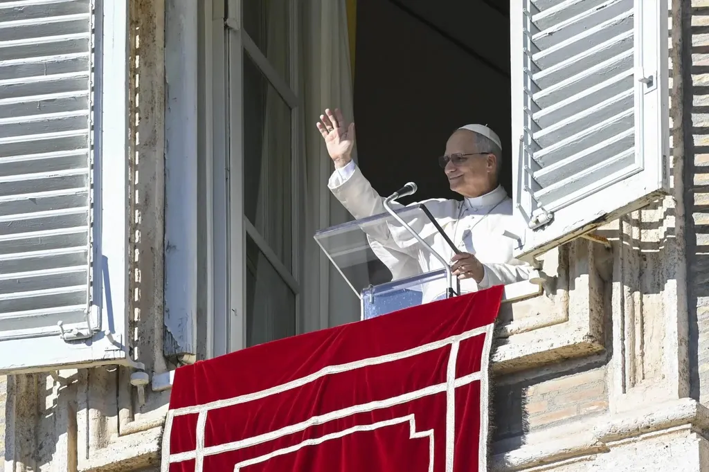 Pope Leo XIV waving from the Angelus window at the Vatican