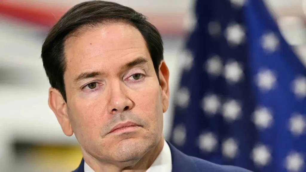 US Secretary of State Marco Rubio in front of an American flag