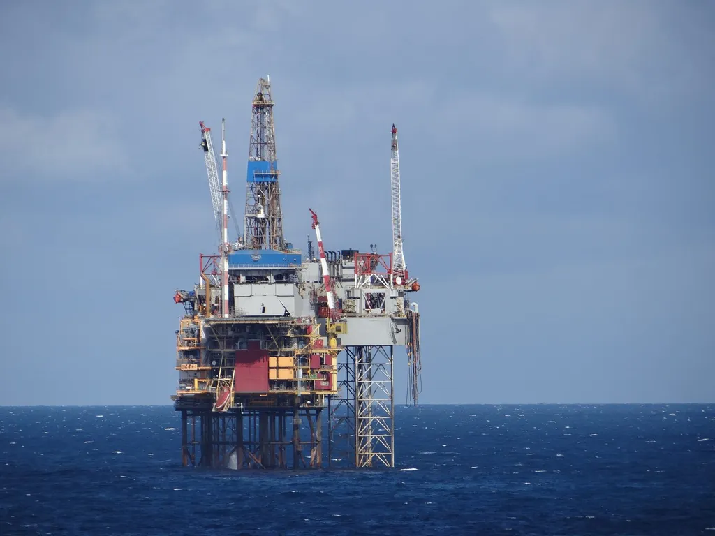 An offshore oil rig in the North Sea, photographed against a blue sky