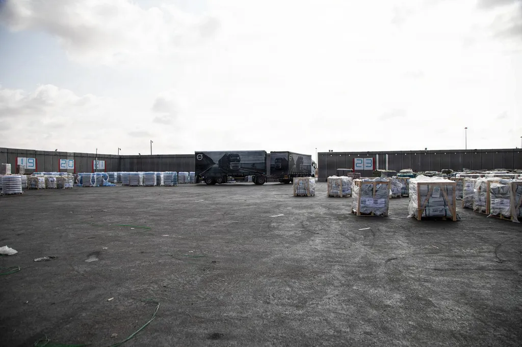 Aid truck and palletised humanitarian supplies at the Kerem Shalom crossing point into Gaza