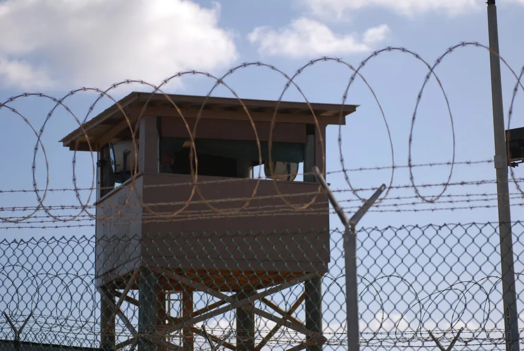 A U.S. Army soldier stands guard in a watchtower above razor wire at Camp Delta, Joint Task Force Guantanamo Bay, Cuba, where the 9/11 defendants face a military commission trial