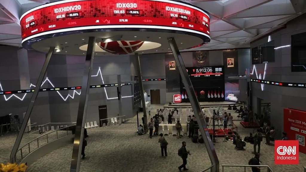The Indonesia Stock Exchange trading hall in Jakarta with red tickers showing falling index boards