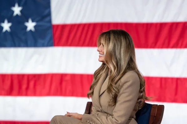 Melania Trump seated before the U.S. flag at the White House