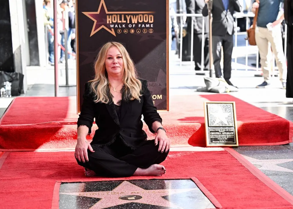 Christina Applegate sitting beside her Hollywood Walk of Fame star on the red carpet