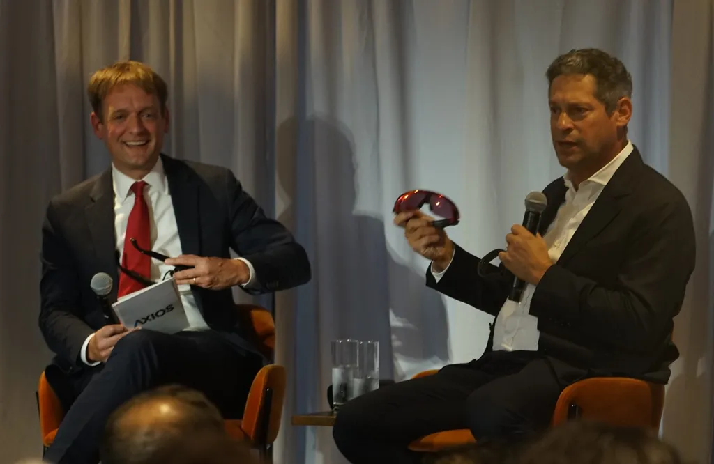 Joel Kaplan, Meta chief global affairs officer, on stage at Axios New York Climate Week 2025, holding a pair of smart glasses.