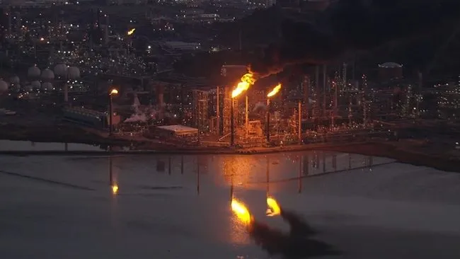Night aerial view of gas flares at a Chevron refinery